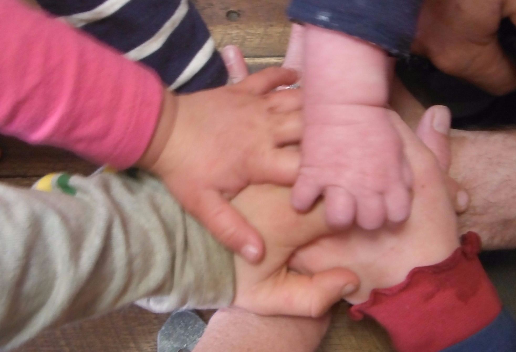farm family all hands in together